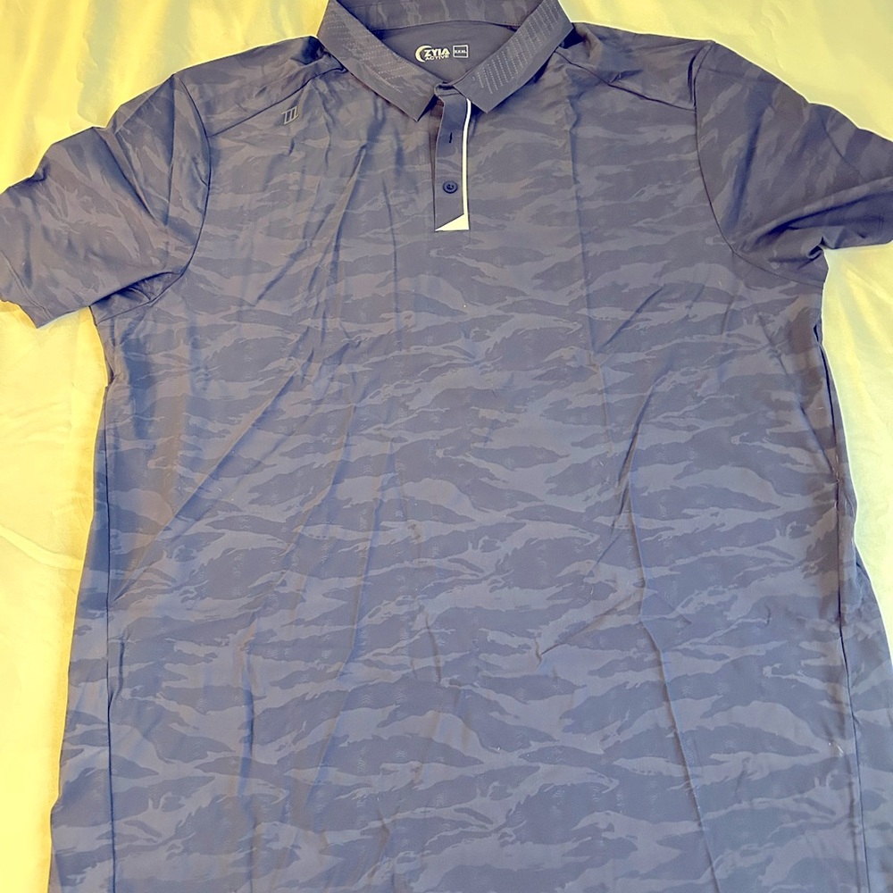 Men’s golf shirt fits small (more like an XXL then XXXL)